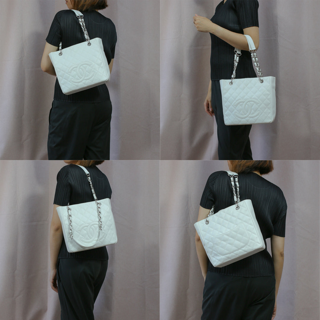 Model carrying the handbag with its chain and leather straps, as a top-handle bag and a shoulder bag.