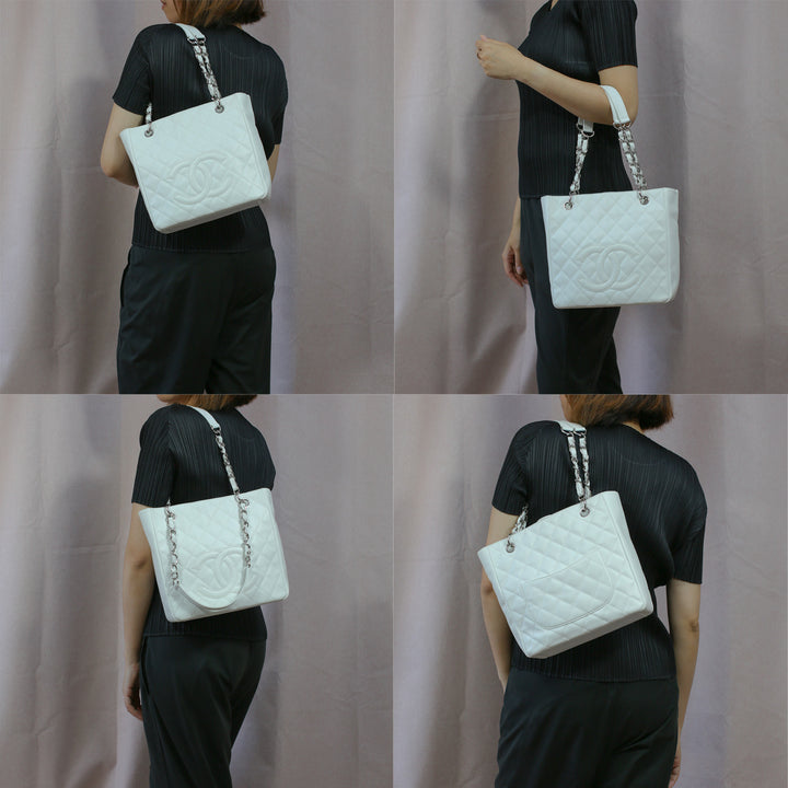 Model carrying the handbag with its chain and leather straps, as a top-handle bag and a shoulder bag.