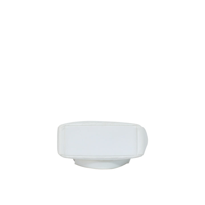 The bottom of the handbag features the Chanel caviar leather in white.