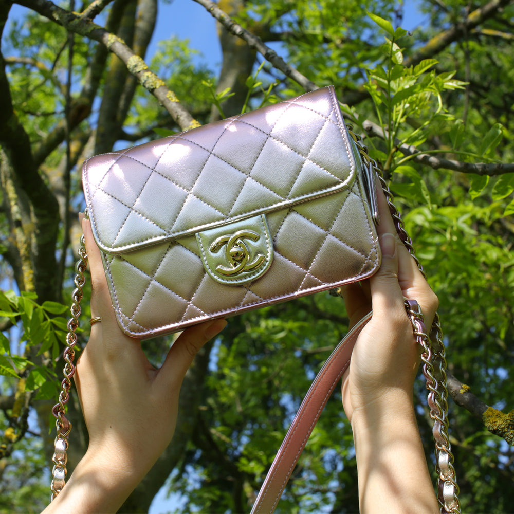 This Chanel bag features a CC turn-lock closure and an interwoven leather and chain strap.