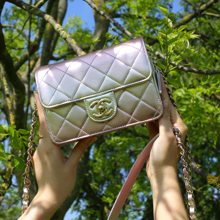This Chanel bag features a CC turn-lock closure and an interwoven leather and chain strap.