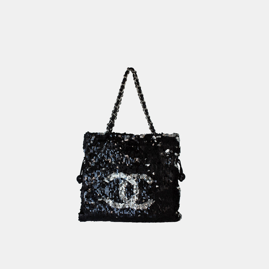 Chanel sequin drawstring shoulder bag in black and silver, with silver-toned hardware.