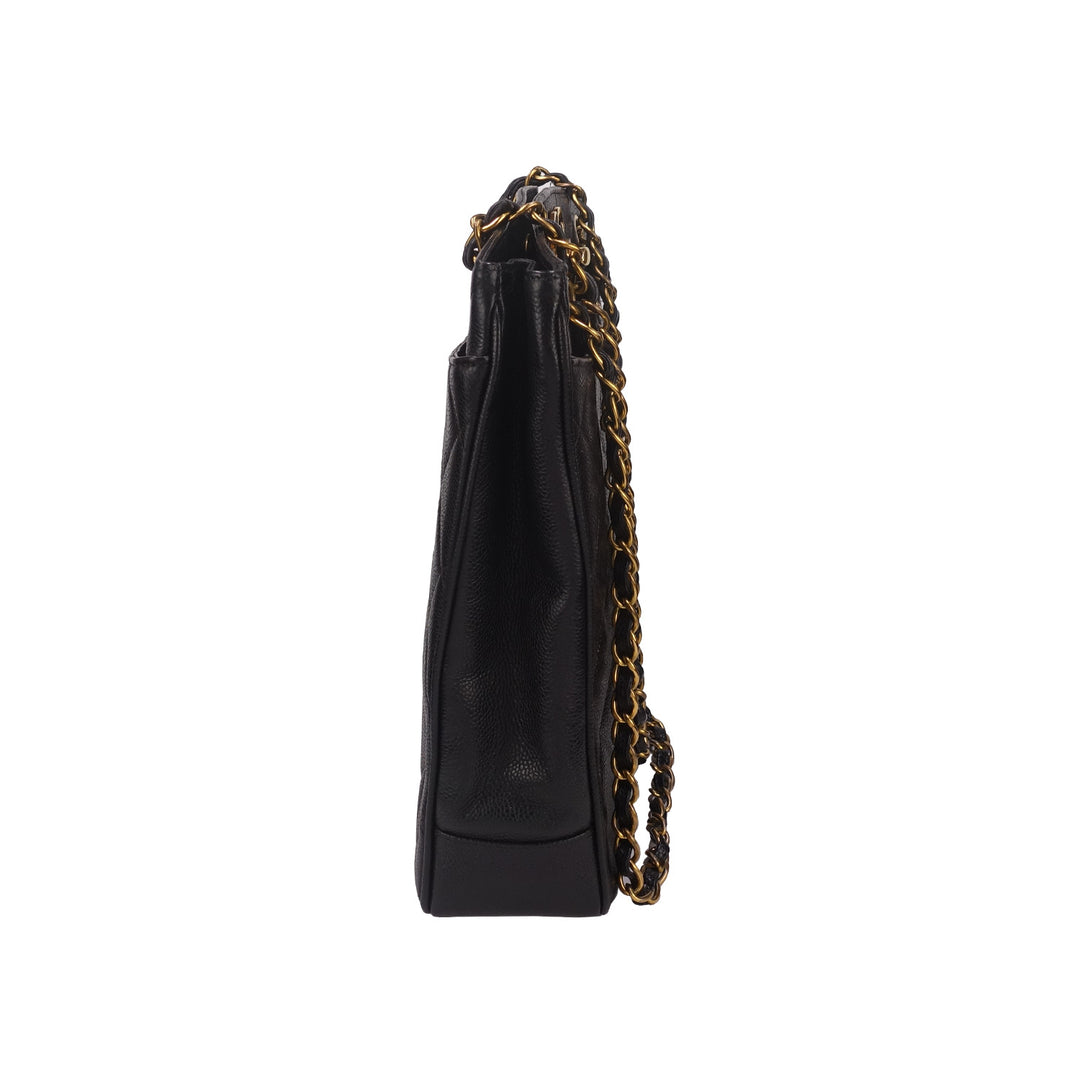 The left side of the bag with the interwoven chain shoulder straps.