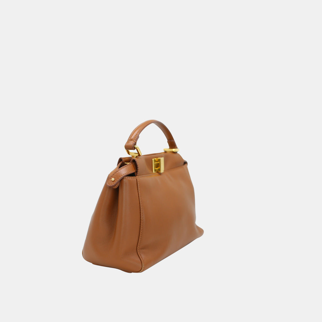 This handbag features a smooth brown leather, and with a twist lock closure.