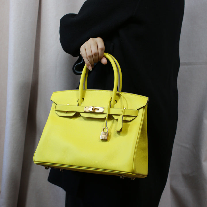 Model wearing the Birkin 30 with its top handles.