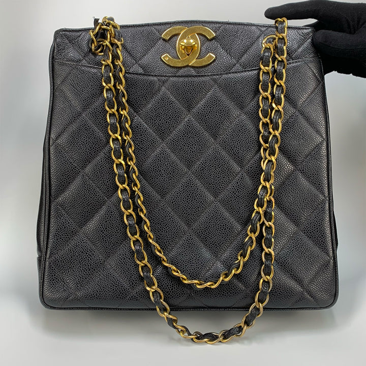 The front of the bag with the CC turn-lock,  the leather chain shoulder straps, and the slip pocket.