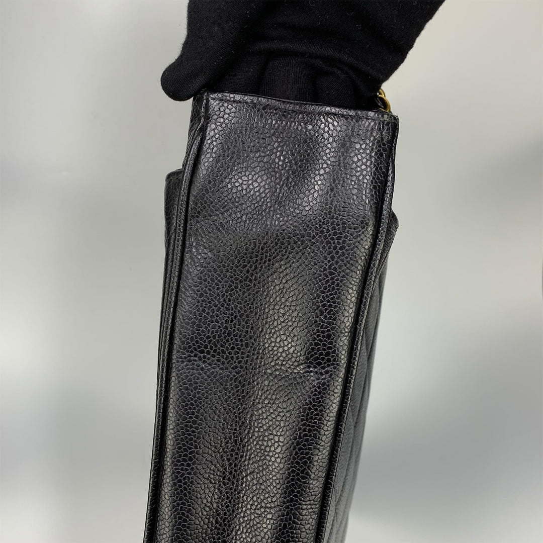 The pebbled texture of the caviar leather.