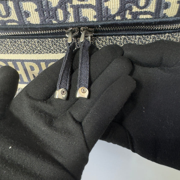 The vanity case features a zip closure with canvas zipper pull tags.