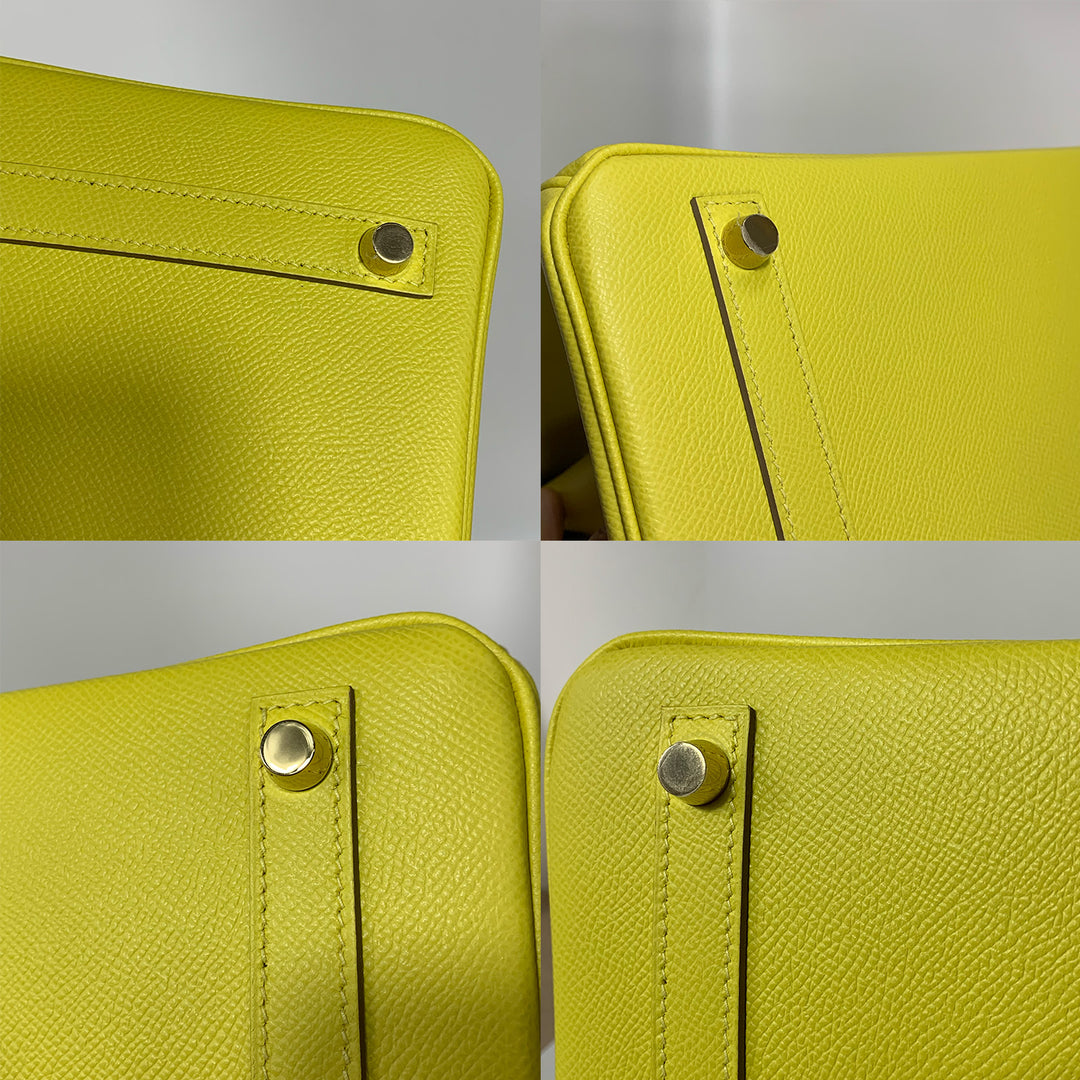 The close-up of the protective feet hardware on the bottom of the handbag.