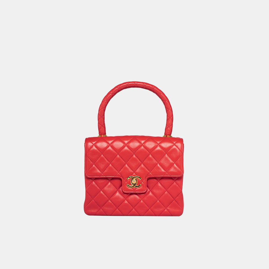 Vintage Chanel Kelly bag in red, made with lambskin leather and 24k gold-plated hardware.