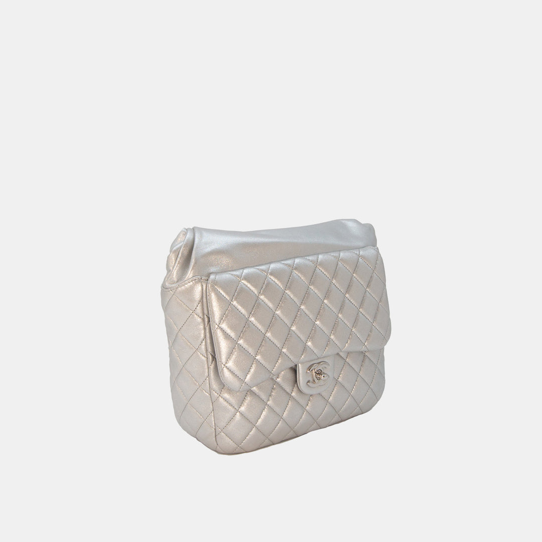 This backpack features the iconic Chanel quilted lambskin leather in silver.