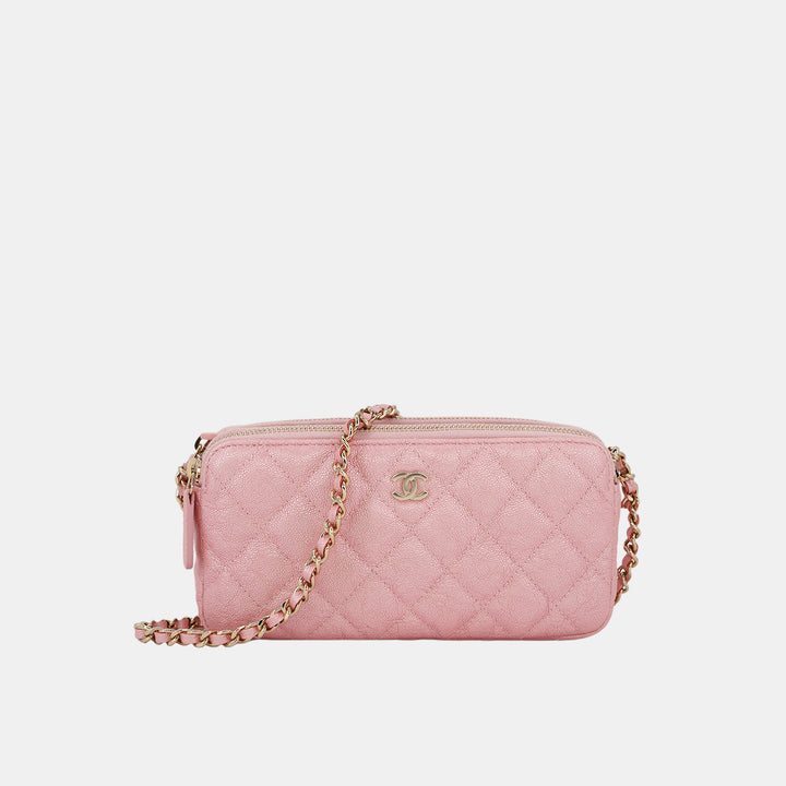 A pink Chanel small clutch with chain strap, featuring gold-toned hardware and the brand's signature diamond quilting.