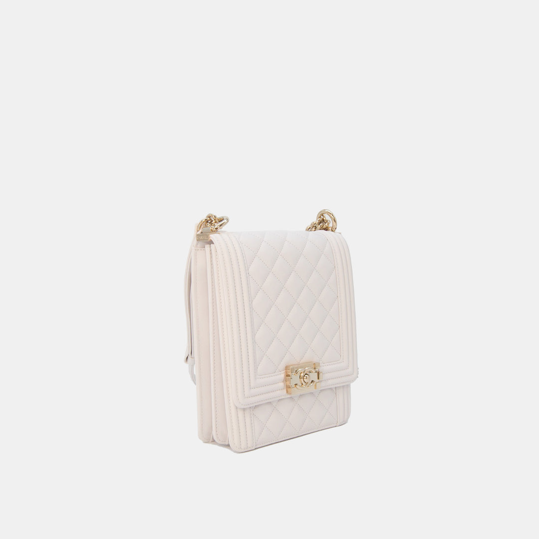 This handbag features a chan and leather strap for shoulder or crossbody wear.