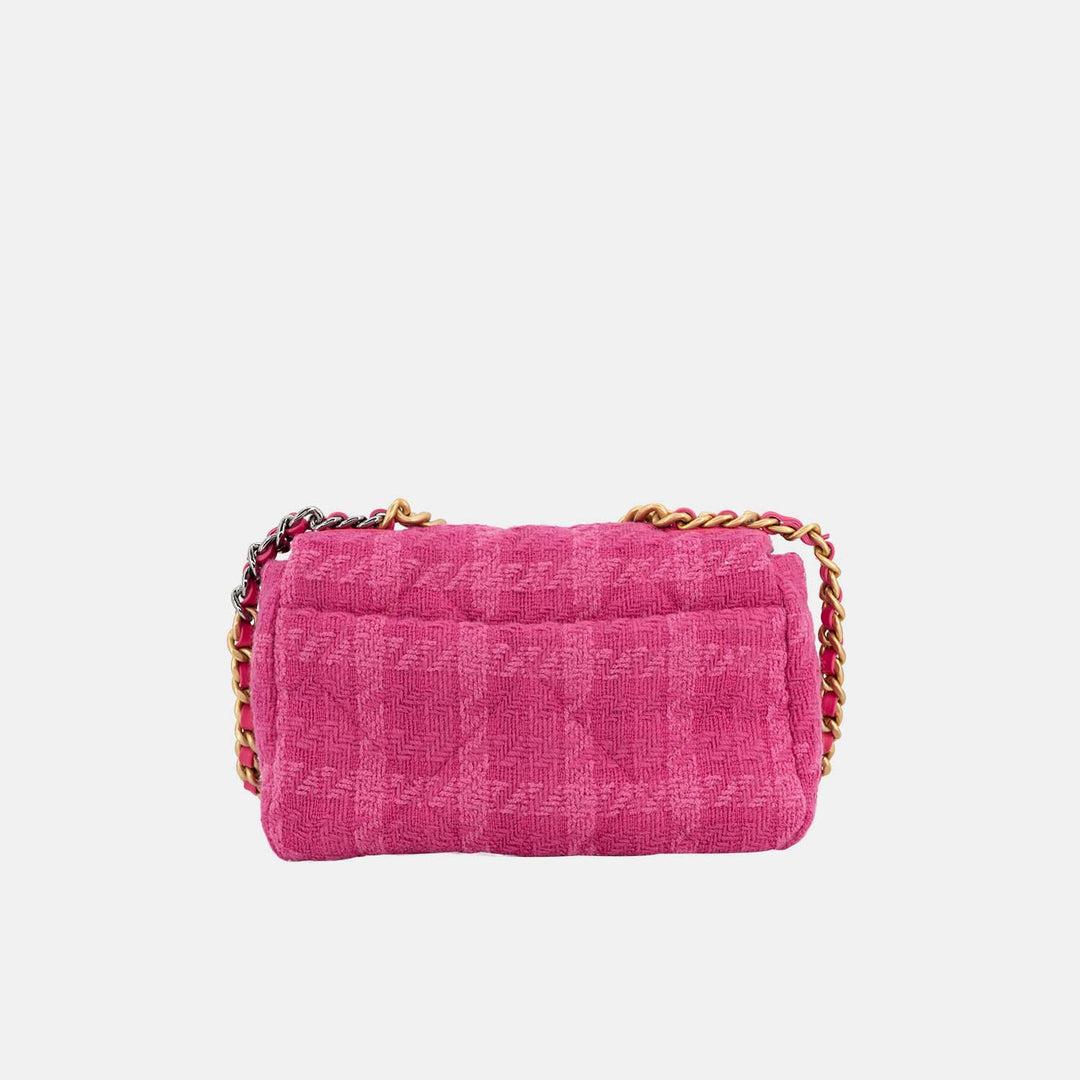 The handbag features a slip pocket on the back.
