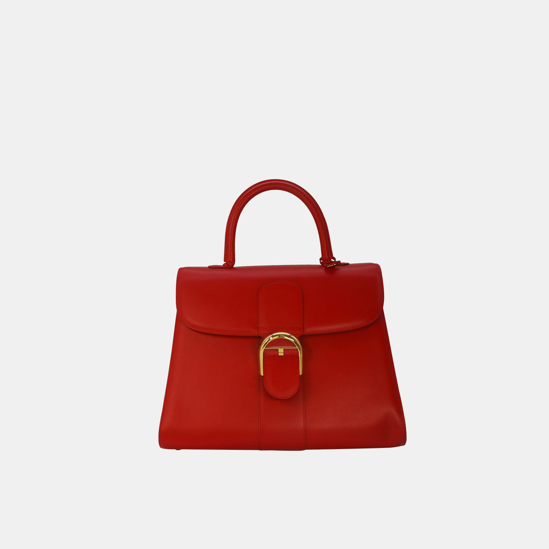 Delvaux Brillant GM bag in red with gold-toned hardware.