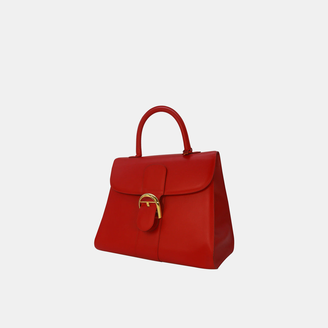 This satchel bag features a front flap with a buckle closure, and a rolled leather top-handle.
