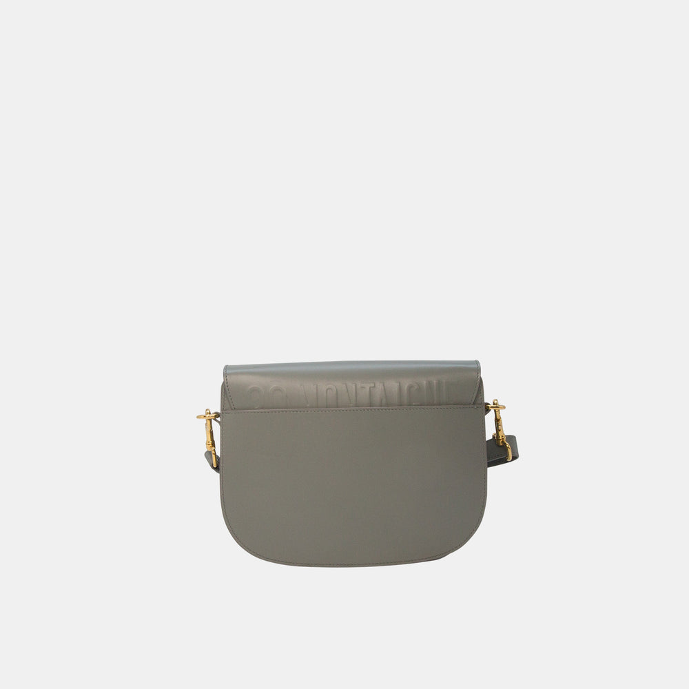 This crossbody bag features a rounded satchel shape, and has Dior’s 30 Montaigne Paris address hand-embossed on the back.