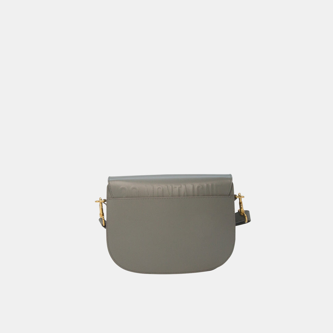 This crossbody bag features a rounded satchel shape, and has Dior’s 30 Montaigne Paris address hand-embossed on the back.