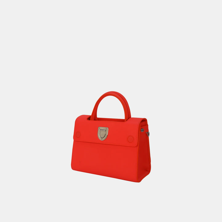 This Dior bag features a magnetic closure with silver-toned hardware.