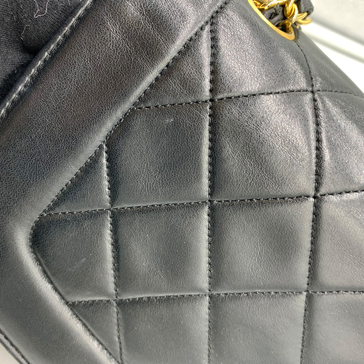 The left side of the flap, showing the diamond quilting and leather texture.