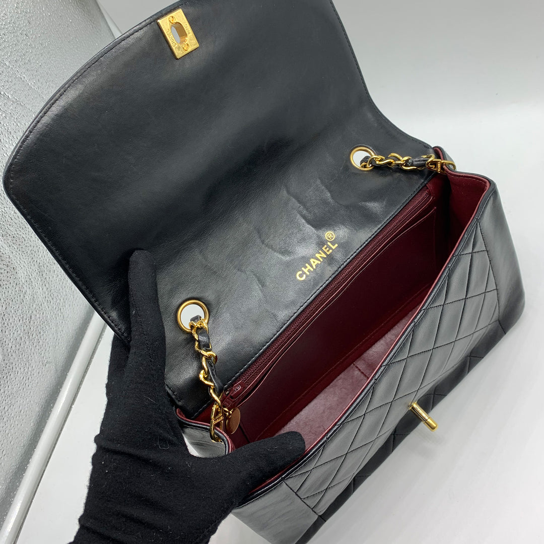 The interior of the bag has a red leather lining.