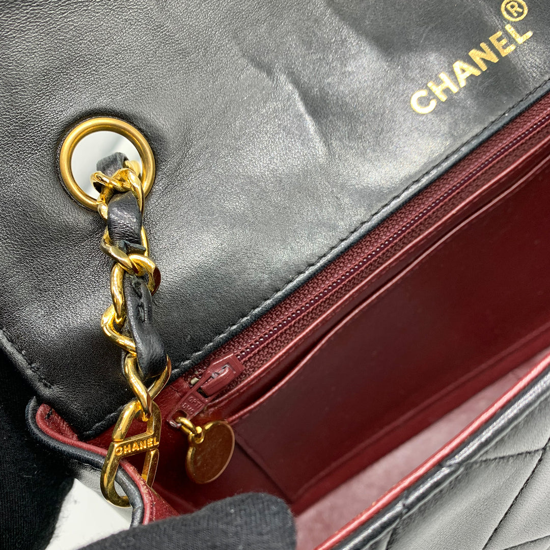 The zip pull tag is a gold-plated charm with CC logo.