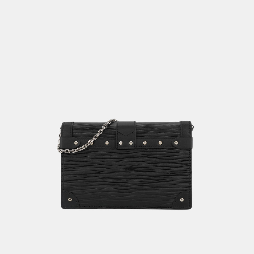 This WOC features elements from the Louis Vuitton trunks, like the corners, studs and the push-lock closure.