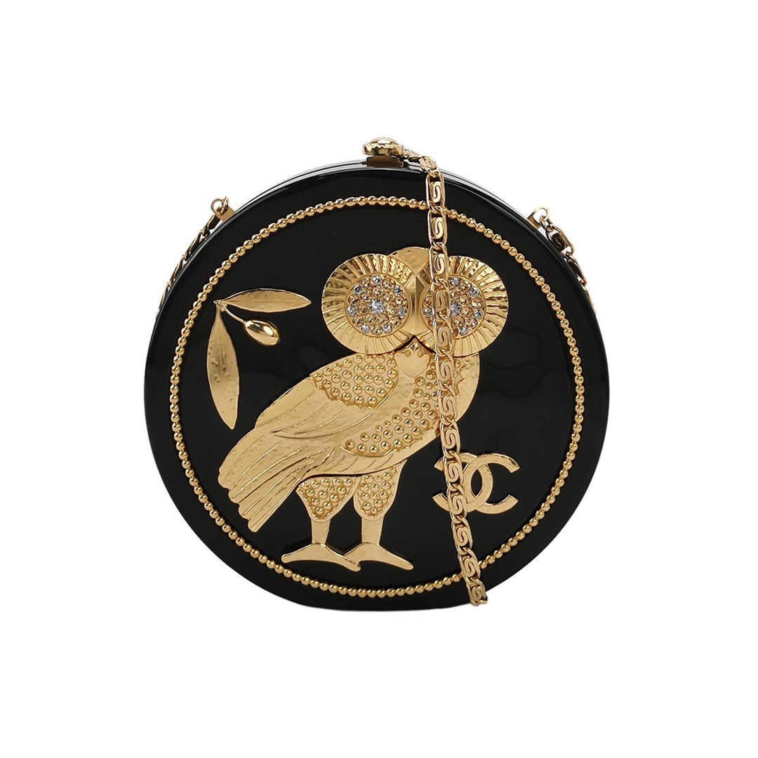 Front of the chain clutch minaudière with gold-toned CC logo and gold-toned owl figure, featuring a gold-toned chain strap. 