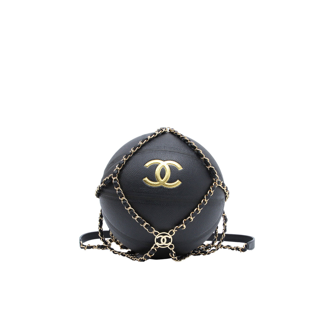 A Chanel basketball with gold-toned CC logo inside the interwoven chain and leather net with a shoulder strap. 