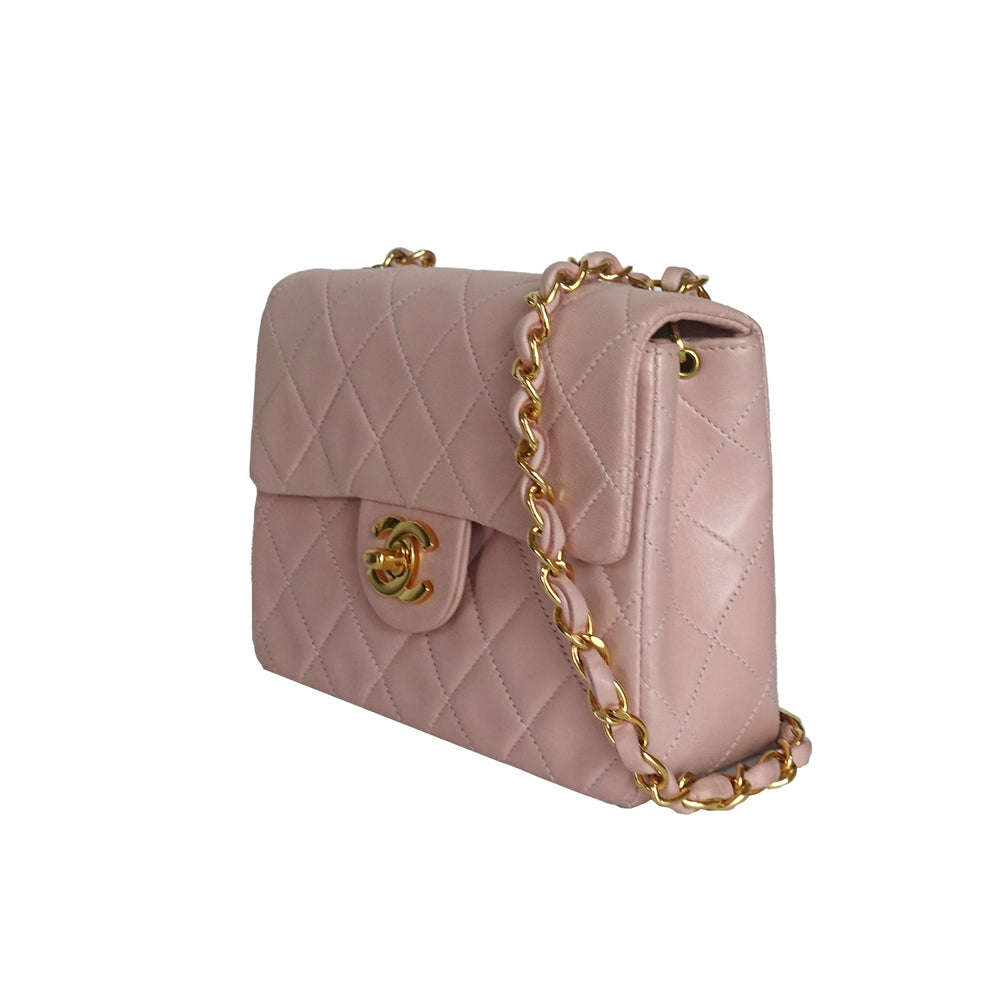 This vintage Chanel bag features the iconic quilted lambskin leather, and in a soft light pink. 