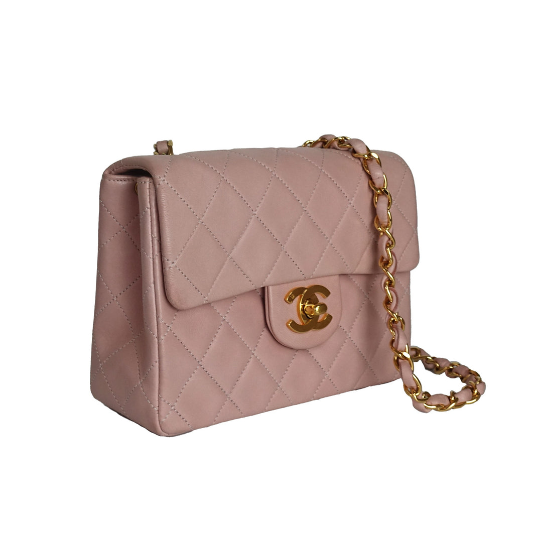 This vintage Chanel bag features 24k gold-plated hardware on the CC turnlock, and the interwoven chain and leather strap.