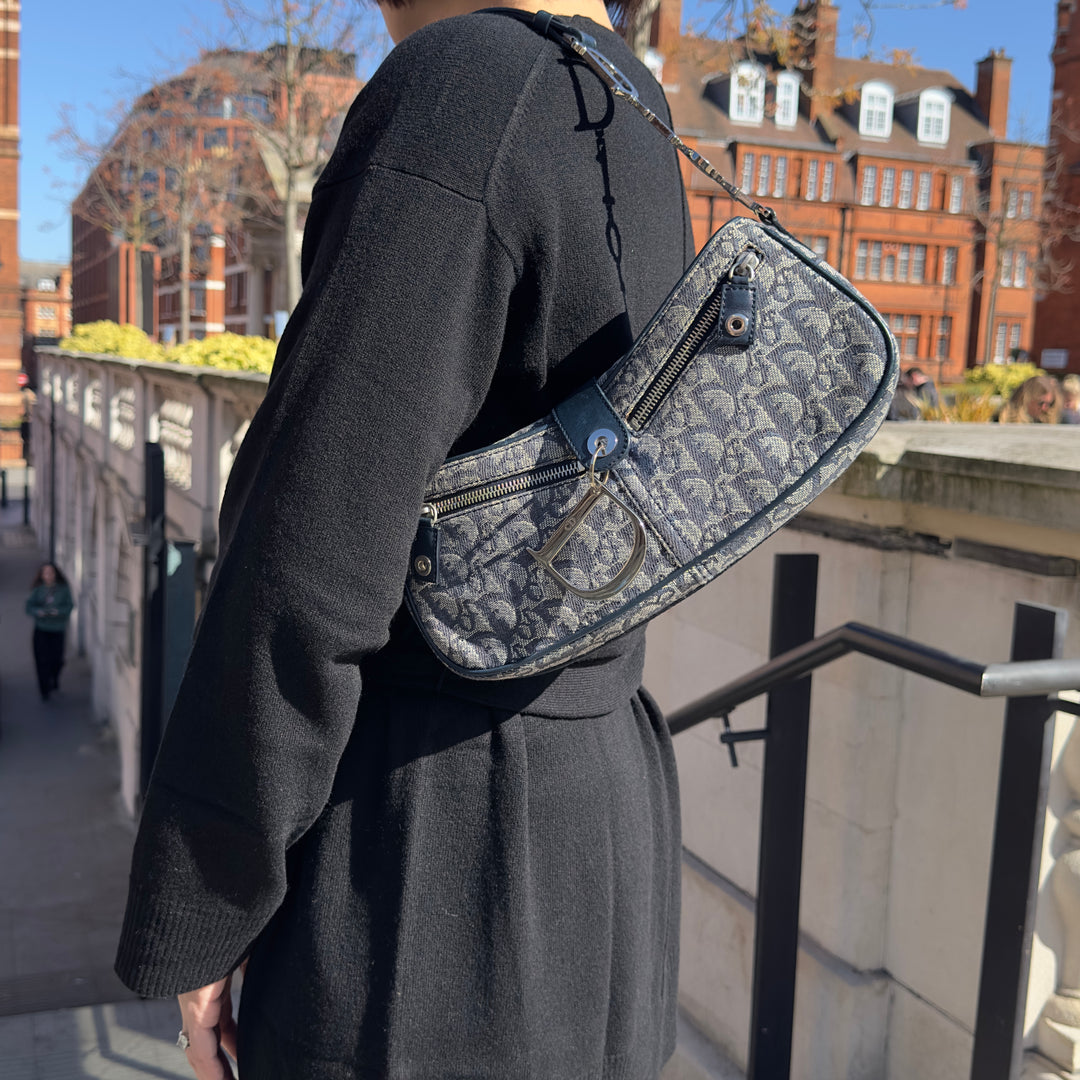 Model showing the Dior Vintage Oblique Trotter Baguette Bag with D Charm Navy Blue Canvas.