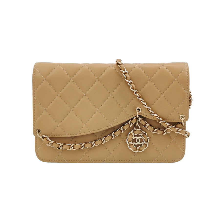Chanel wallet on chain beige quilted with gold chain and logo charm.