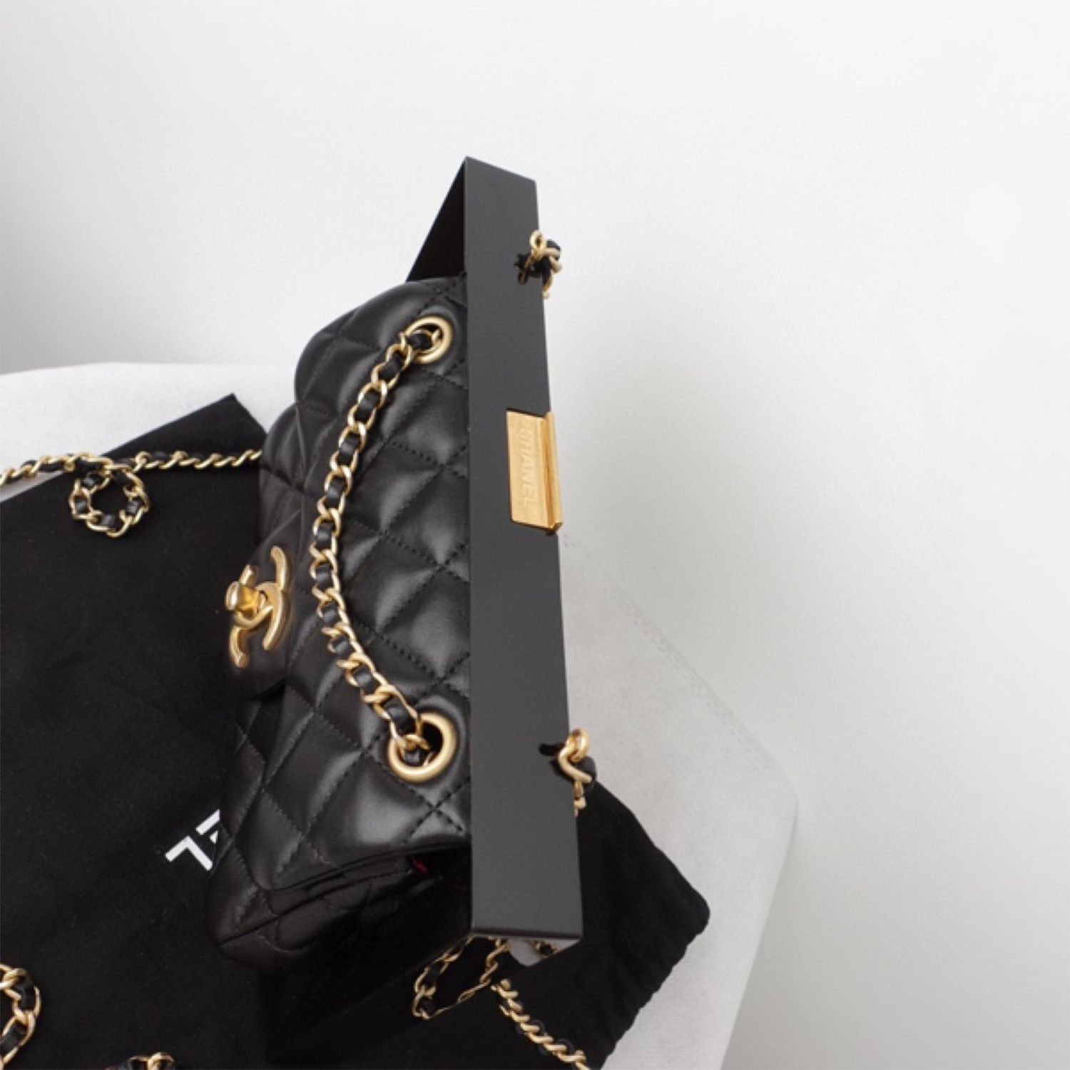 Chanel bag with gold plate on top hotsell