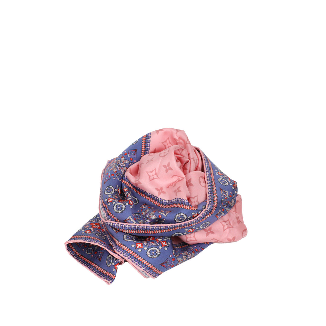 A luxurious pink silk scarf from Louis Vuitton featuring the iconic Monogram logo pattern.