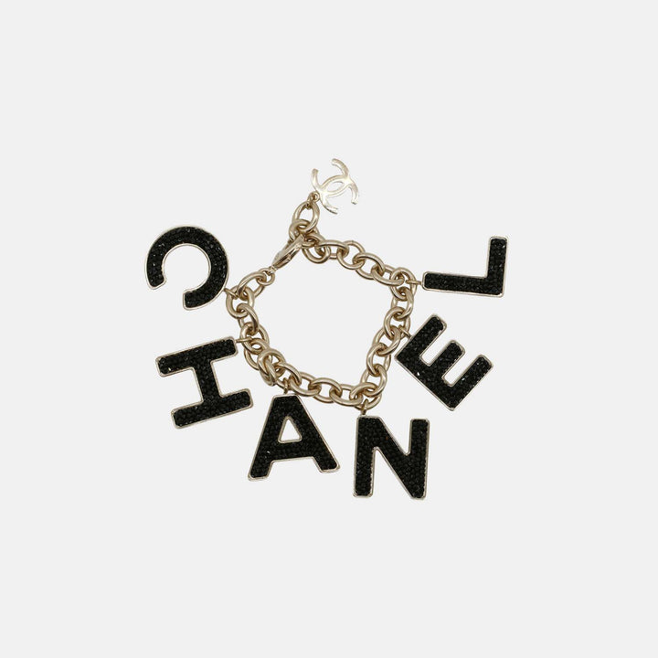 The Chanel Charm Bracelet with Chanel letters encrusted with crystals, and a CC charm. 